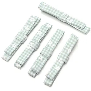 Green checkered floral bow fabric ribbon DIY accessory, delicate detail shot for crafts.