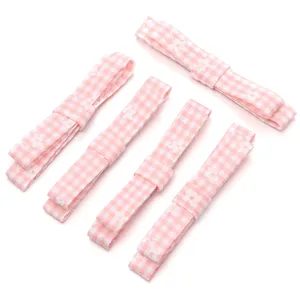 Close-up detail of pink checkered floral fabric bows for DIY hair accessory crafting.