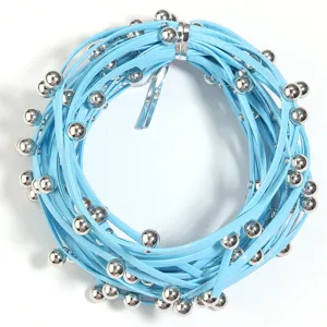 Detailed view of light blue leather cord with silver beads, punk style DIY jewelry making material.