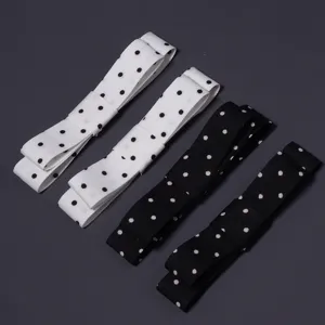 Detalle de cinta de lazo de lunares de poliéster que muestra diseño de doble capa para accesorios.