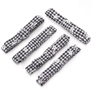 Black and white plaid fabric ribbon bows, DIY hair accessories and clothing sewing craft supplies.