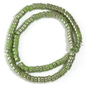 Green electroplated wheel spacer beads detail view, glossy glass DIY jewelry accessory for crafting.