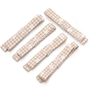 Close-up detail of brown plaid floral ribbon strips, perfect for DIY hair bows and craft accessories.