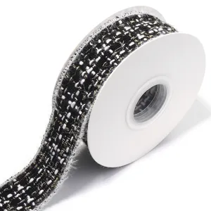 Textured black white tweed ribbon roll with gold threads for DIY hair bows and gift wrapping.
