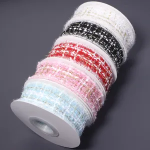 Close-up of colorful tweed ribbon rolls, perfect for DIY crafts and gift box wrapping.
