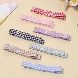 Detailed close-up view of multi-color plaid floral fabric hair bows and DIY hair clip accessories.