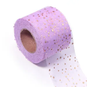 Detailed view of light purple tulle mesh roll featuring shiny gold foil stars texture.