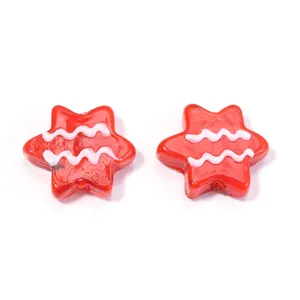 Close-up of red star-shaped glass beads with white wavy lines, perfect for DIY jewelry making.