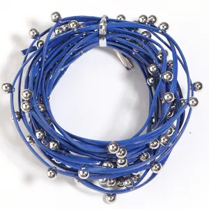Close-up detail of blue beaded leather cord necklace, punk style multi-layer fashion jewelry.