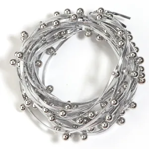 Detailed shot of silver metallic beaded leather cord, punk style DIY clothing jewelry material.