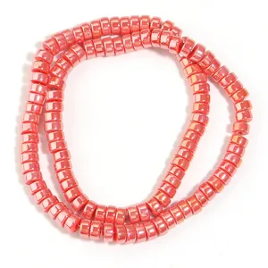 Close-up detail of pink electroplated wheel spacer beads, perfect for DIY jewelry crafting.