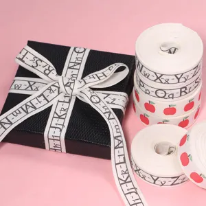 Cotton ribbon featuring apple and alphabet letters, perfect for gift wrapping and DIY crafts.