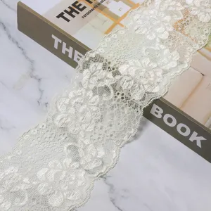 Detail view of white floral lace ribbon trim for DIY sewing and clothing accessories design.
