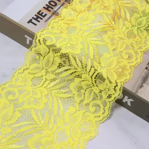 Detail view of bright yellow stretch lace trim fabric, perfect for garments, cuffs, and DIY crafts.
