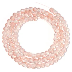 Detail view of pink crackle glass round beads, perfect for DIY bracelets and necklaces.