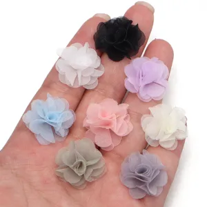 Colorful chiffon fabric flowers close up, handmade DIY craft accessories and sewing supplies.