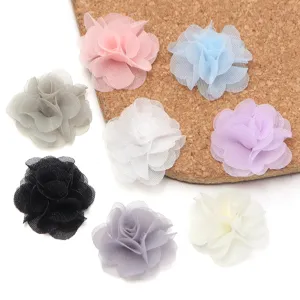 Close-up details of colorful chiffon flower DIY accessories, perfect for hair clips and crafting.