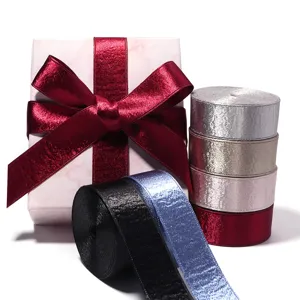 Metallic ribbon rolls and gift box bow set for gift wrapping and crafting details.