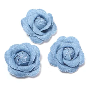 Close-up of light blue denim fabric camellia flowers, perfect for DIY clothing and accessories.