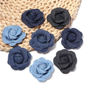 Close-up details of vintage denim fabric camellia flower accessories, multi-color DIY floral patches.