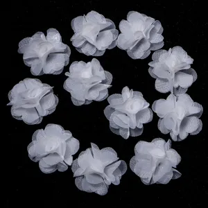 Close-up view of white chiffon flower accessories, perfect for DIY crafts and hair bows.