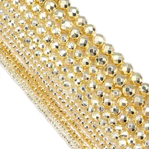 Close-up detail of metallic gold faceted hematite loose beads showcasing sparkling texture.