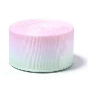 Single-sided gradient grosgrain ribbon, pink and green roll detail for DIY crafts and gift boxes.