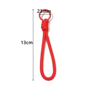 Red handmade braided phone lanyard with metal ring, anti-lost strap pendant accessory.