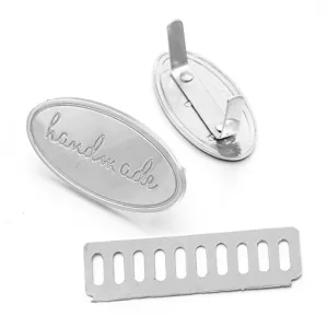 Metal oval handmade bag label close-up display, premium DIY hardware accessory detail view.