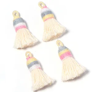Close-up of gradient short plump shiny silk cotton tassels with hanging loop for DIY jewelry.