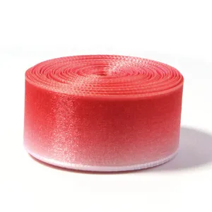 Close-up detail of the gradient ribbon roll, showing smooth color transition and glossy texture.