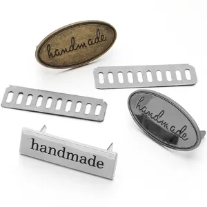 Metal handmade labels and parts close-up view, perfect for DIY bags and crafts detailing.