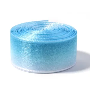 Close-up of light blue gradient sheer organza ribbon roll, delicate texture for gift wrapping.