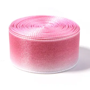 Close-up of pink gradient sheer ribbon roll, showing delicate organza texture and details.