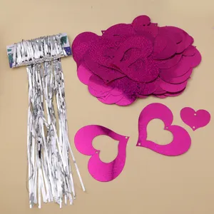 Silver tinsel fringe curtain and pink holographic heart pendants for party wedding decorations.