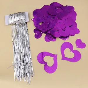 Purple holographic heart pendants and silver fringe tinsel curtain for wedding Valentine's decor.
