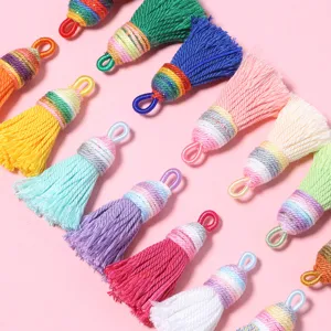 Colorful cotton tassels detail close up, perfect for DIY jewelry earrings and bag key chain pendants.