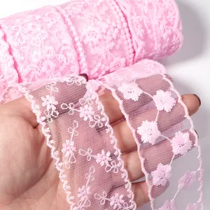 Close up of pink lace trim with delicate floral embroidery, perfect for soft DIY craft details.