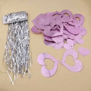 Silver tinsel fringe and pink holographic hollow heart shaped sequins for wedding party decoration detail.