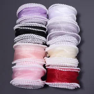 Detailed close-up of colorful organza ribbons featuring elegant pearl beaded edge trims.