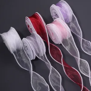 Close-up of colorful sheer organza ribbons featuring delicate white pearl beaded edges for gifts.