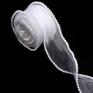 Detail view of a white organza ribbon roll with delicate pearl bead trim for crafts.