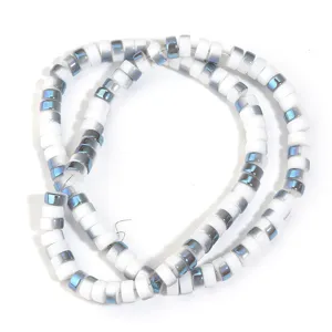 Close-up of white electroplated glass wheel spacer beads, perfect for DIY jewelry making.