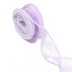 Detailed view of the light purple organza ribbon with delicate pearl beaded edge trim.