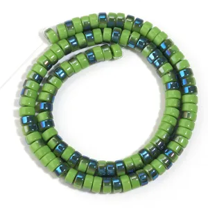 Close-up detail of green electroplated glass wheel spacer beads for DIY jewelry crafting.