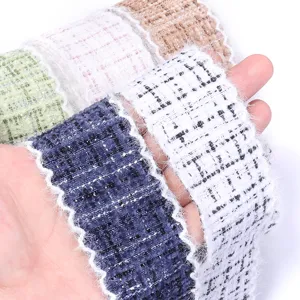 Close-up view of tweed boucle ribbon trim, fringed edge fabric tape for DIY crafts and apparel.