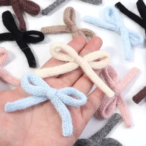 Detailed shot of cute knitted bow accessories in candy colors, soft plush material for DIY.