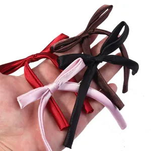 Detailed view of handmade satin ribbon bows in multi colors for DIY apparel and hair accessories.