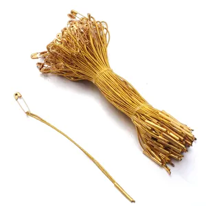 Gold hang tag strings with safety pins, metal locking fasteners for clothing and tags.