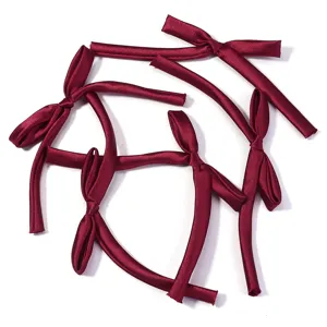 Satin ribbon bow DIY hair accessories and elegant gift wrapping decorations in burgundy.